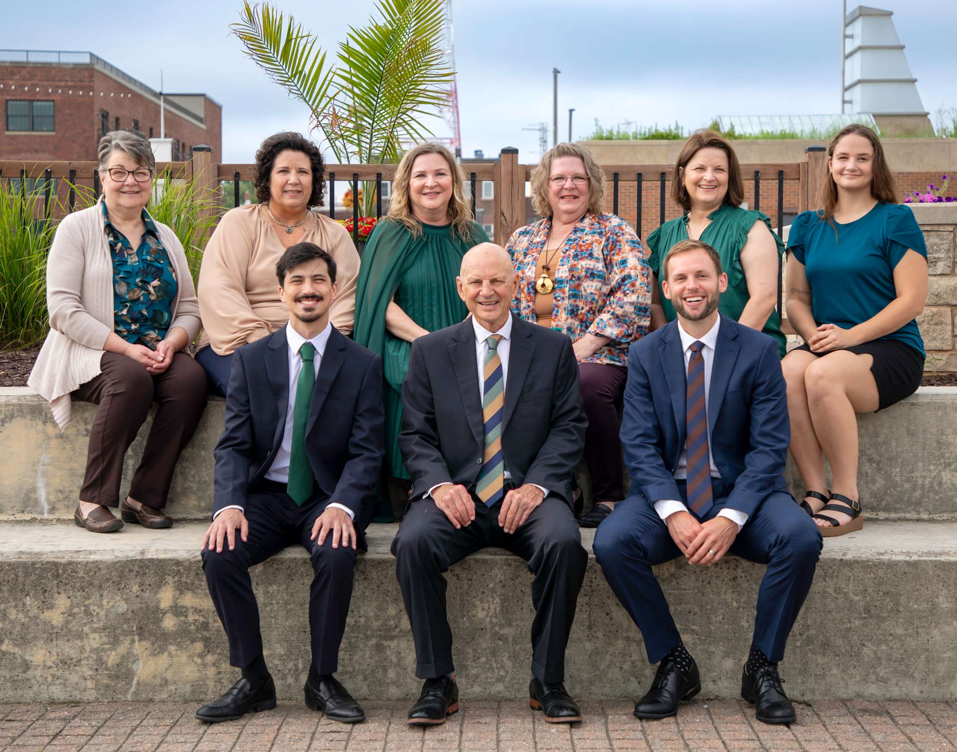 Wessels Law Firm employees sitting in front of a fountain in downtown Rock Island, IL